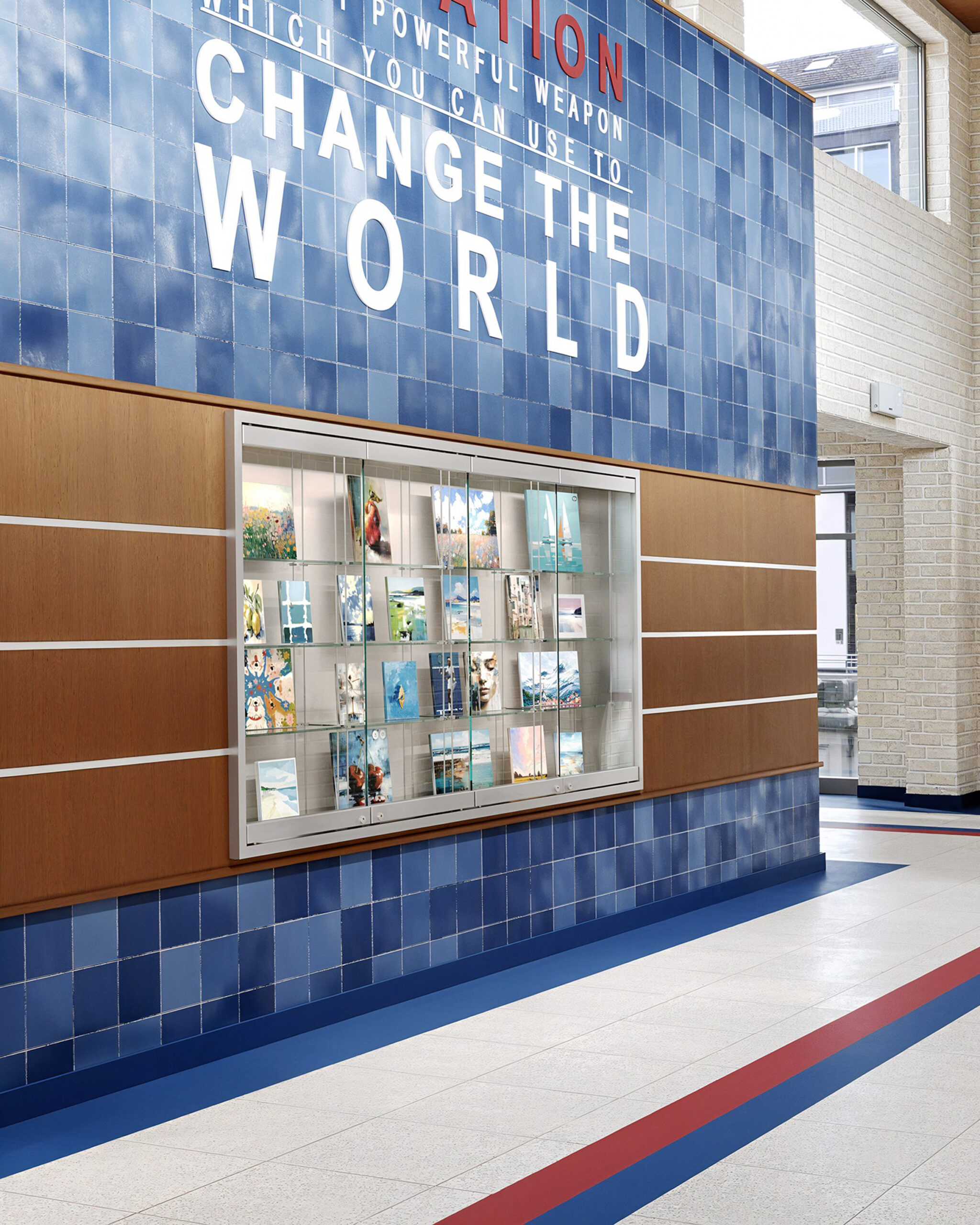 Glass display case with student art in school hallway