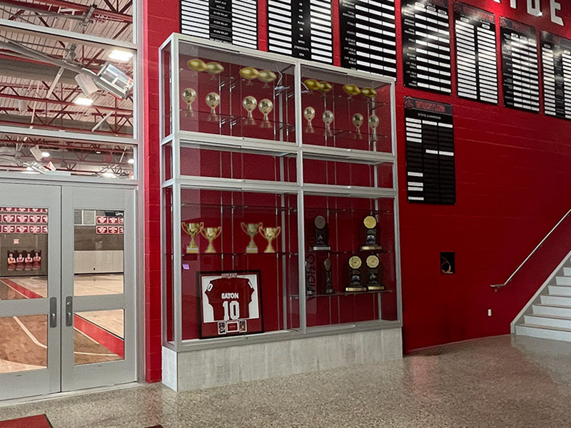 Trophy display case outside school gym