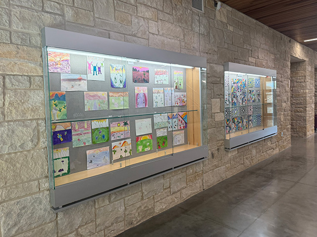 Glass display cases holding student art